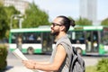 Man traveling with backpack and map in city Royalty Free Stock Photo