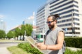 Man traveling with backpack and map in city Royalty Free Stock Photo