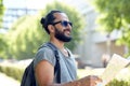 Man traveling with backpack and map in city Royalty Free Stock Photo