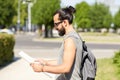 Man traveling with backpack and map in city Royalty Free Stock Photo