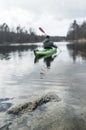 Man traveling in the kayak on the lake.