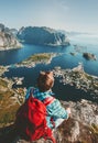 Man traveling in Norway sitting on cliff edge