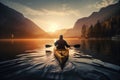 A man travelling in a kayak in a lake at sunrise in mountains is a peaceful and serene scene that captures the beauty