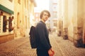 A man travels in Europe. A man smiles, walks through the streets of the old city, with a briefcase. Royalty Free Stock Photo