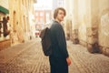 A man travels in Europe. A man smiles, walks through the streets of the old city, with a briefcase. Royalty Free Stock Photo