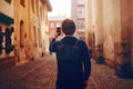 A man travels in Europe street. A man smiles, walks through the streets of the old city, with a briefcase. Student travels alone. Royalty Free Stock Photo