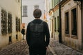 A man travels in Europe street walks through the streets of the old city, with a briefcase. Student travels alone. A young man Royalty Free Stock Photo