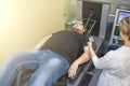 Man on treatment recovery physiotherapy of human spine by stretching with special medical equipment in clinic