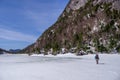 Man trekking across a frozen lake