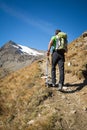 Man trekking in the Alps in a beautiful sunny day. Grand Paradiso National Park. Italy