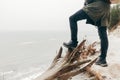 Man trekking in winter standing on cliff over the sea. Royalty Free Stock Photo