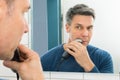 Man trimming beard