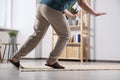 Man tripping over rug at home, closeup