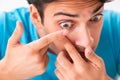 The man trying contact lenses at home Royalty Free Stock Photo