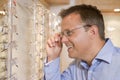 Man trying on eyeglasses at optometrists