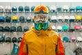 Man trying on three masks for ski or snowboarding