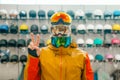 Man trying on three masks for ski or snowboarding