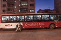 A man trying to catch crowded bus in the evening in MAputo, Africa