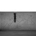 Man trying to climb over wall with business doodles Royalty Free Stock Photo