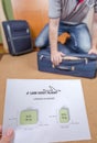 Man trying to close full hand luggage Royalty Free Stock Photo