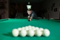 Man trying to hit the ball in billiard. Billiard room on the background Royalty Free Stock Photo
