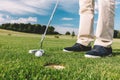 Man trying to put a golfball into the hole.