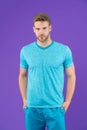Man in tshirt and shorts on violet background. Guy in blue casual clothes. Macho in active wear for workout or training on purple