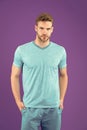 Man in tshirt and shorts on violet background. Guy in blue casual clothes. Macho in active wear for workout or training