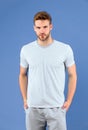 Man in tshirt and shorts on violet background. Guy in blue casual clothes. Macho in active wear for workout or training