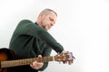 a man tunes a guitar male hands and a guitar close-up of a musician playing an acoustic guitar. Music white background Royalty Free Stock Photo