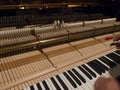 Man tunes a piano