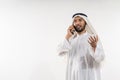 man in a turban is calling using a mobile phone while smiling