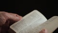 Man turning the pages of the English explanatory dictionary