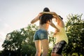 Mann turning woman dancing in the grass in summer park Royalty Free Stock Photo