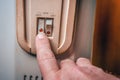 The man turns on the heater. Close-up of the hand, power buttons and temperature control