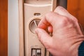 The man turns on the heater. Close-up of the hand, power buttons and temperature control