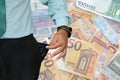 Man turns up his trouser pocket and Euro money notes background Royalty Free Stock Photo