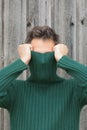 Man with turtleneck covering face