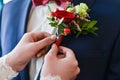 Man in a tux fixing his cufflink