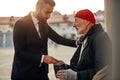 Rich man help senior beggar