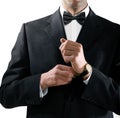 Man in tuxedo puts on watch Royalty Free Stock Photo