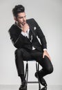 Man in tuxedo thinking, holding one hand to his chin. Royalty Free Stock Photo