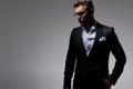 Man in tuxedo wearing glasses holding one hand in pocket Royalty Free Stock Photo