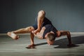 Man twisted on the floor in a yoga pose. Hand to feet yoga pose.