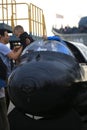 A man and two boys near the Soviet ultra-small submarine project 907 `Triton-1M`. Front view close up