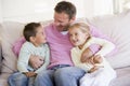 Man and two children sitting in living room Royalty Free Stock Photo