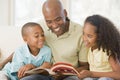 Man and two children sitting in living room