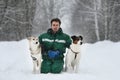 Two dogs walk outdoors in winter with an owner Royalty Free Stock Photo