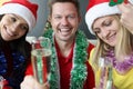 Man and two women celebrate New Year and Christmas Royalty Free Stock Photo