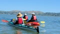 Man and two women kayaking in calm water